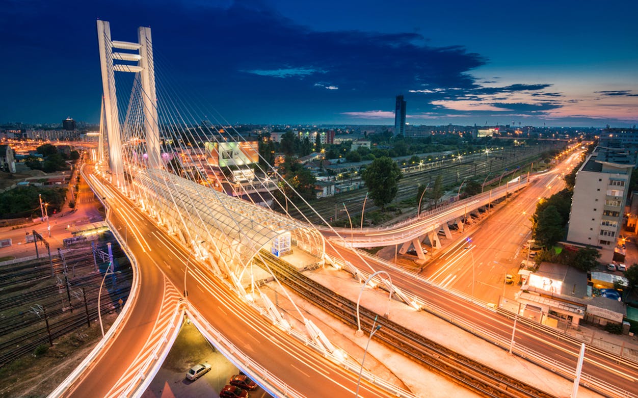 Bucharest's Basarab Bridge illuminated at night during an after-dark sightseeing tour.