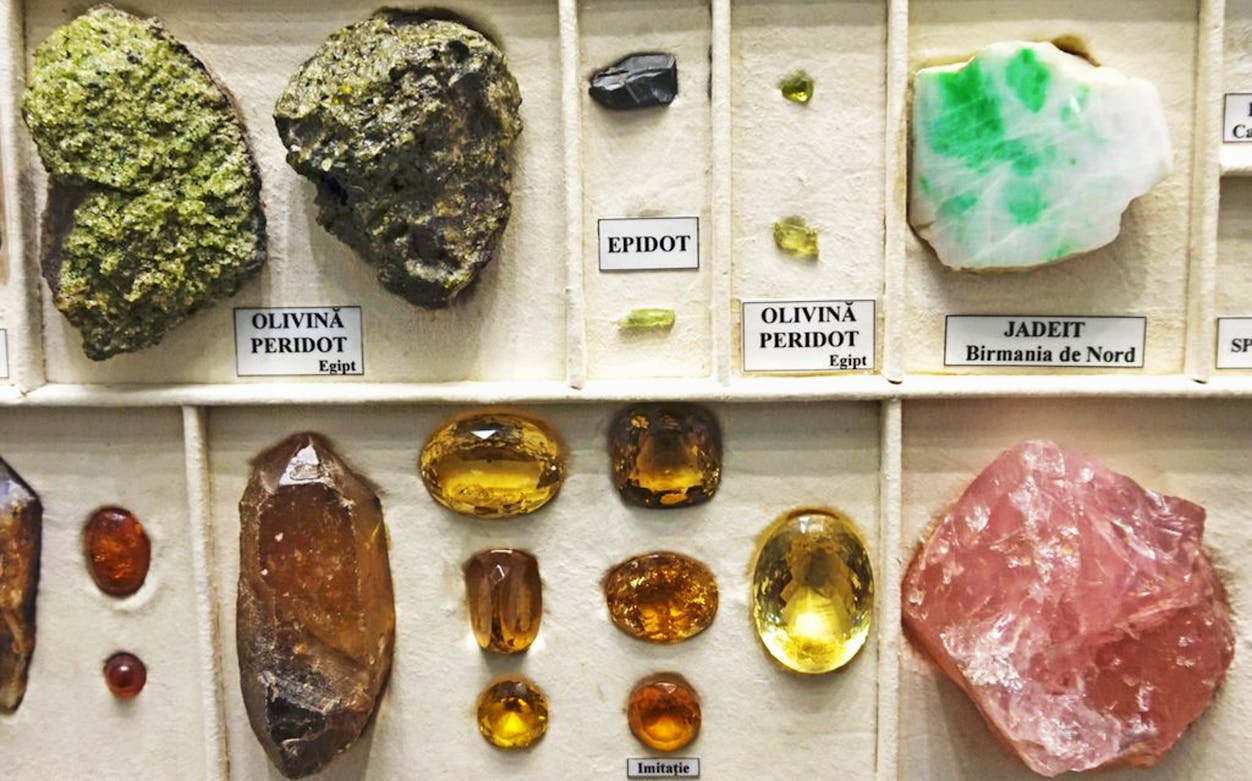 Gemstone display at Grigore Antipa National Museum of Natural History, featuring peridot, jadeite, and amber.