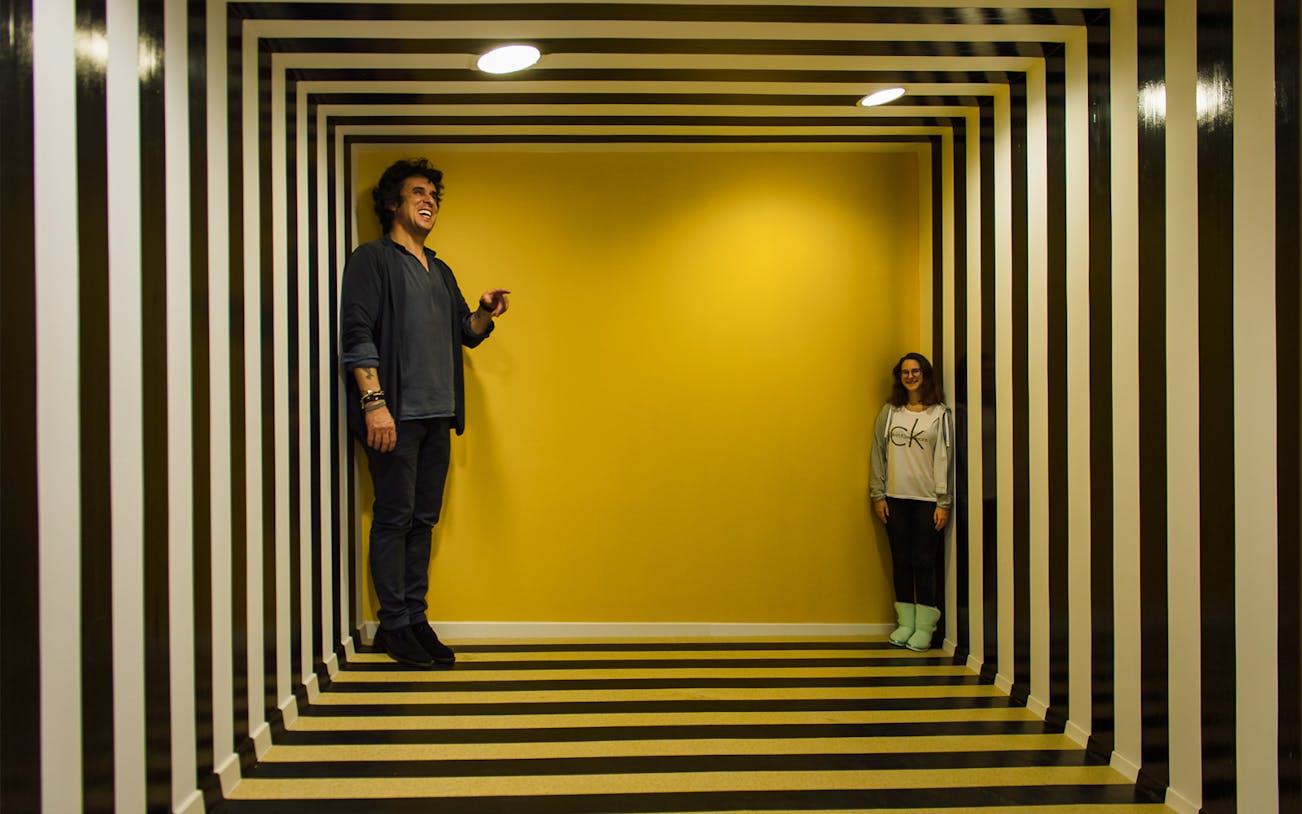 Visitors in an optical illusion room at Museum of Senses, Bucharest.