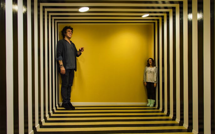Visitors in an optical illusion room at Museum of Senses, Bucharest.