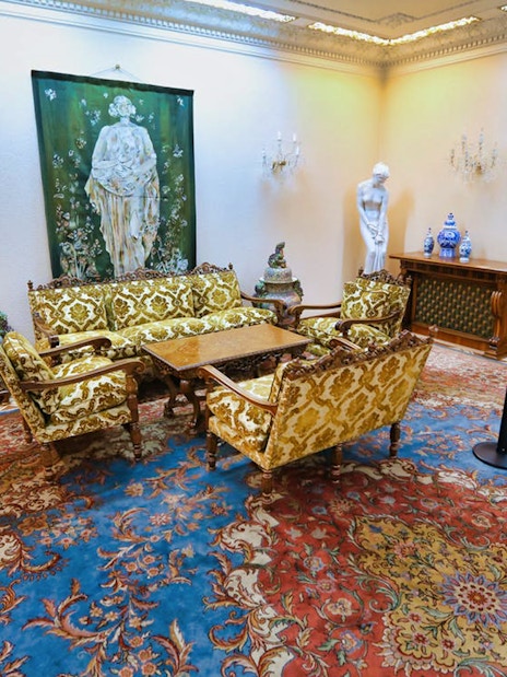 Elegant sitting room in Ceausescu Mansion with ornate furniture and artwork.