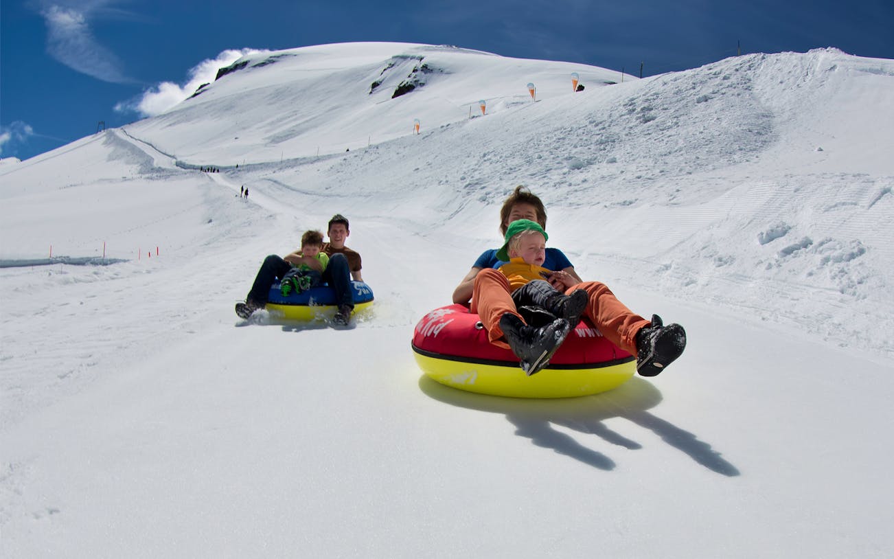 Snow tubing on Mount Titlis, Lucerne, with families enjoying the snowy slopes.