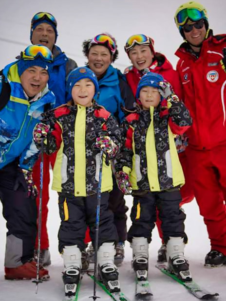 Group of skiers posing on a snowy slope in Jungfrau Region, Switzerland.