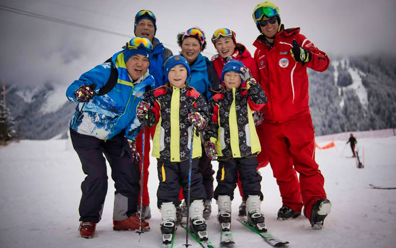 Group of skiers posing on a snowy slope in Jungfrau Region, Switzerland.