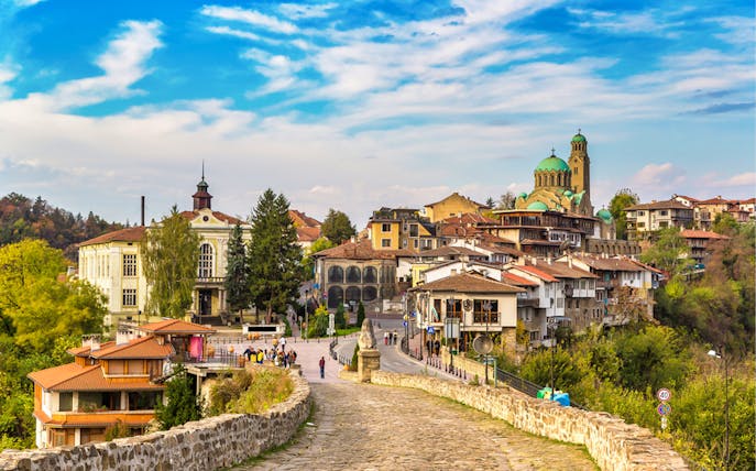 Cobbled street leading to Veliko Tarnovo with medieval architecture, Bulgaria.
