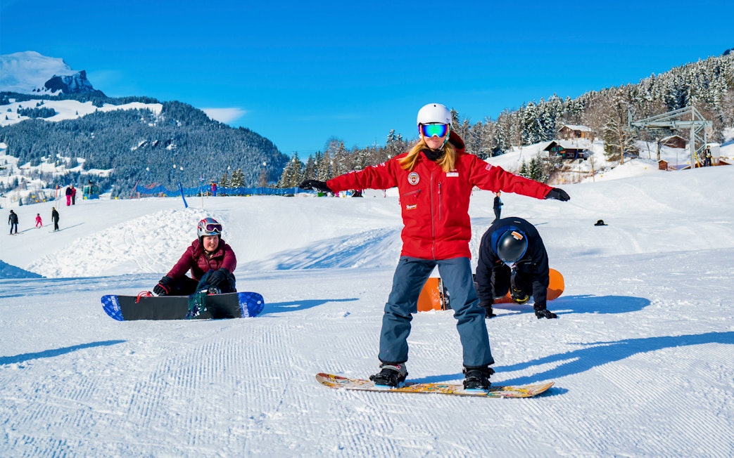Beginner skiers learning on snowy slopes in Grindelwald with scenic mountain backdrop.