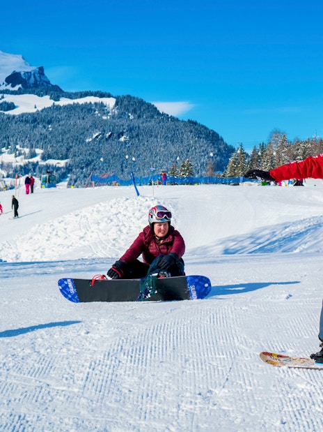 Beginner skiers learning on snowy slopes in Grindelwald with scenic mountain backdrop.