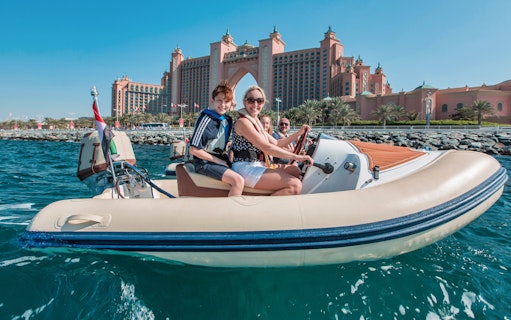 Family enjoying a self-drive boat tour near Atlantis, The Palm in Dubai.