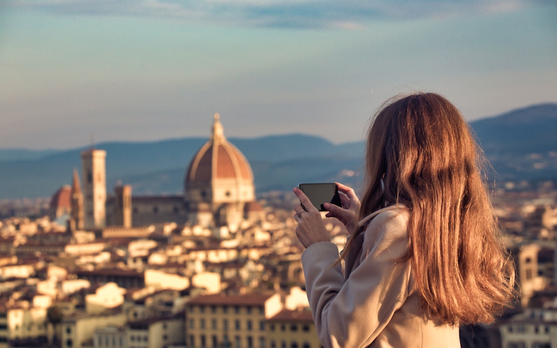 Person photographing Florence skyline with the Duomo in view.