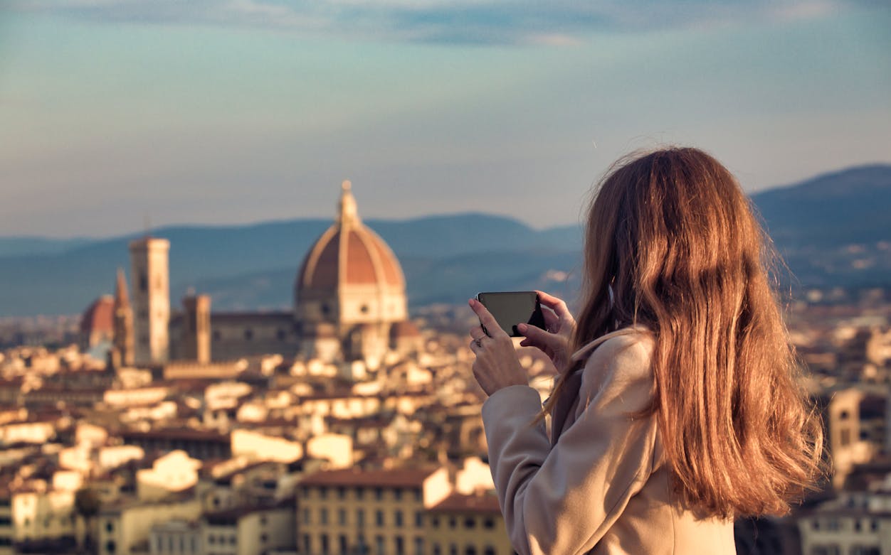 Person photographing Florence skyline with the Duomo in view.