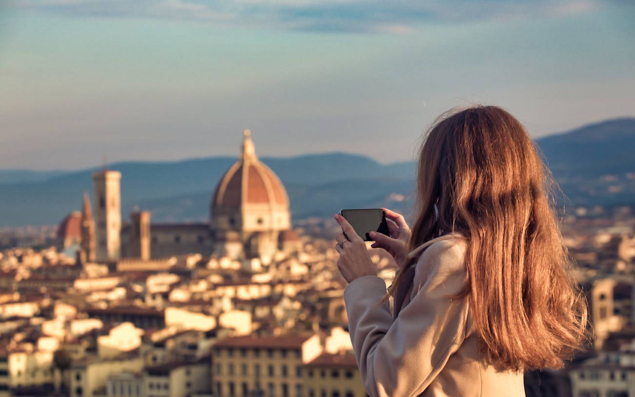 Person photographing Florence skyline with the Duomo in view.