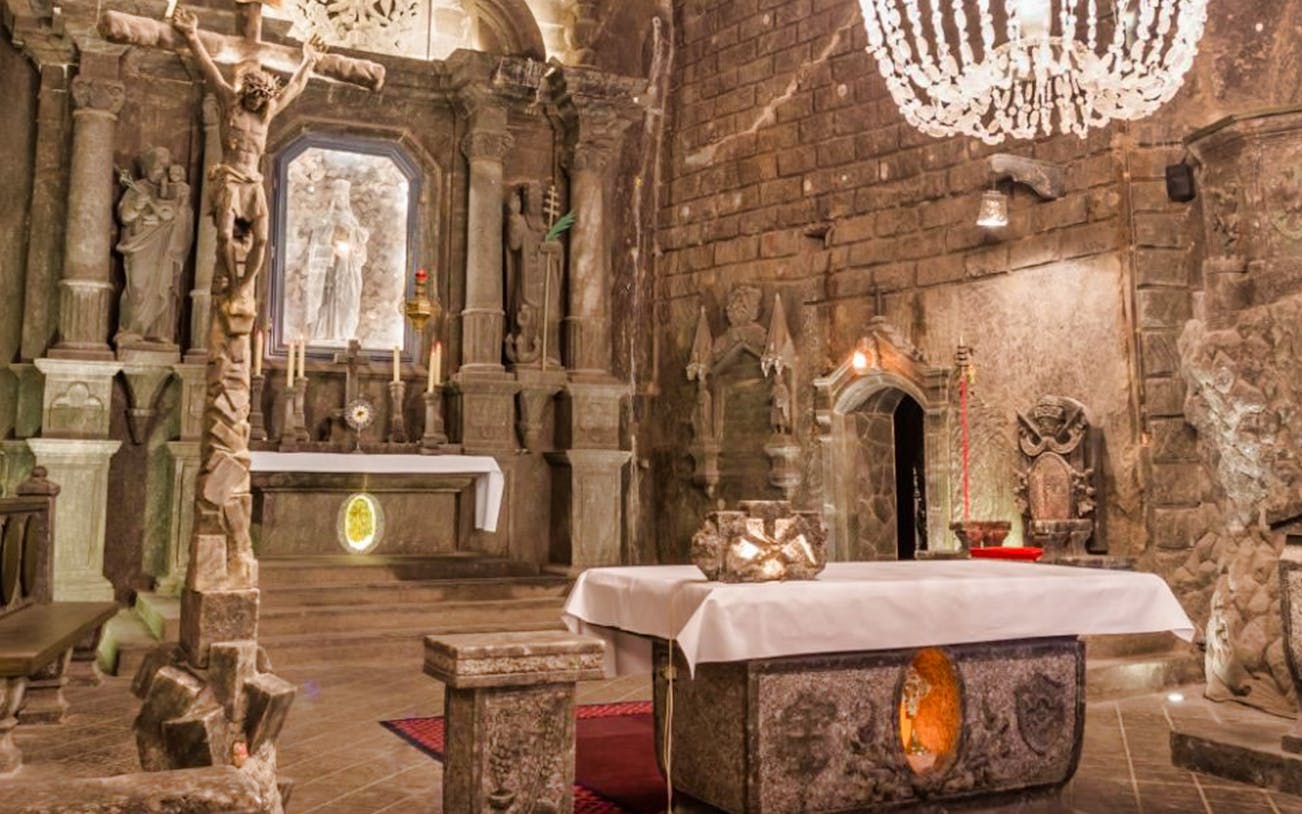 Wieliczka Salt Mine chapel with carved altar and chandeliers on small group tour.
