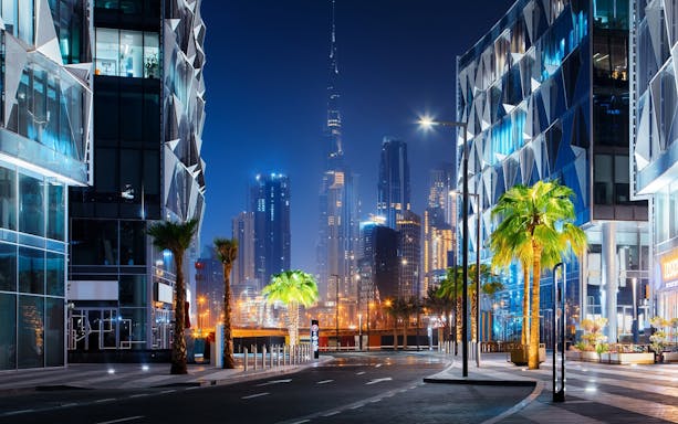 Dubai night skyline with Burj Khalifa and modern architecture on a guided tour.