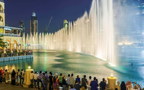 Crowd watching Dubai Fountain show during guided night tour.