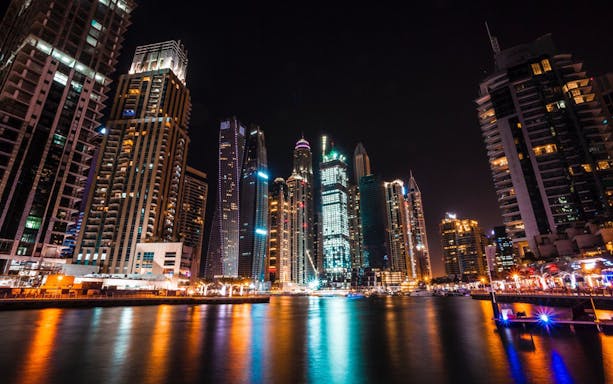 Dubai Marina skyline illuminated at night during a guided tour.