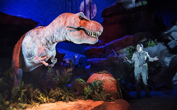 Dinosaur exhibit with guide at Dinópolis Teruel, Spain.