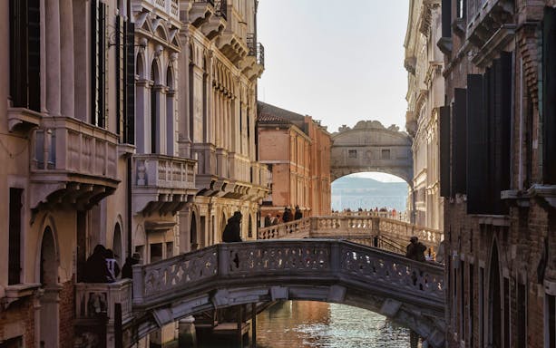 Venice canal view with the Bridge of Sighs in the background, part of a self-guided tour.