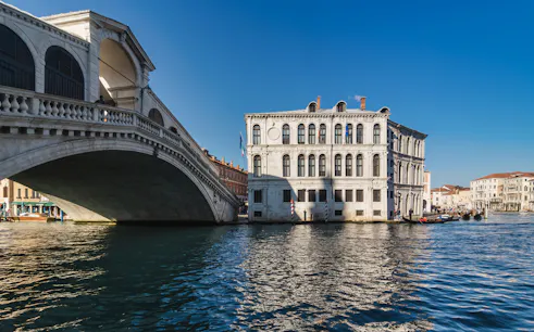 Rialto Bridge over Grand Canal in Venice on a sunny day.