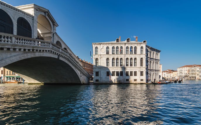 Rialto Bridge over Grand Canal in Venice on a sunny day.