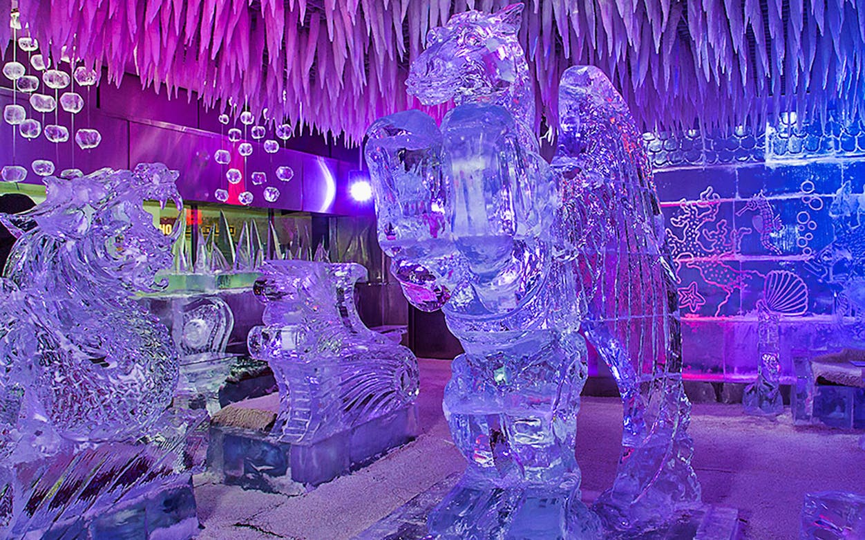 Ice sculptures in Chillout Ice Lounge Dubai with colorful lighting.