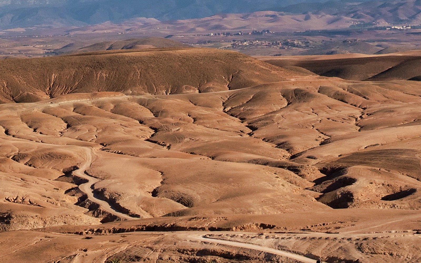 Agafay Desert landscape with winding paths, Morocco.