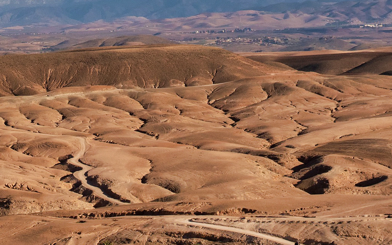 Agafay Desert landscape with winding paths, Morocco.