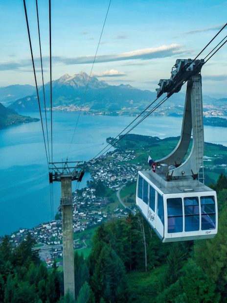 Cable car ascending Mount Rigi with view of Lake Lucerne and surrounding mountains.