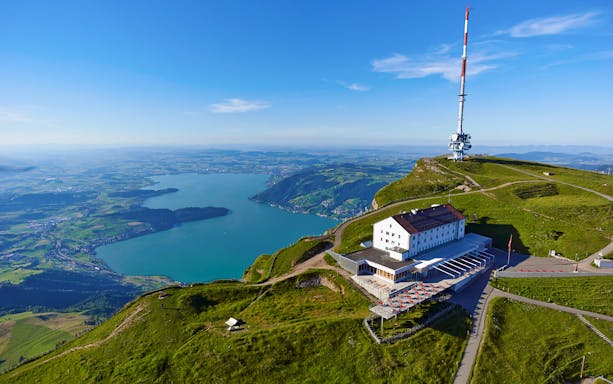 Mount Rigi summit view with lake and Swiss restaurant, Switzerland.