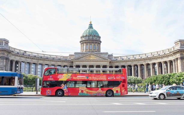 Red double-decker tour bus in front of Kazan Cathedral, St. Petersburg.