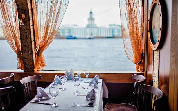 Dining table with view of St. Petersburg's Kunstkamera from a boat, part of CityPass tour.