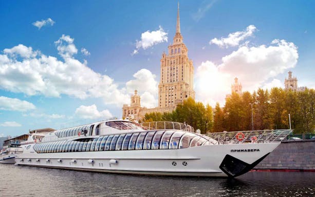 Cruise boat on Moscow River with Stalinist skyscraper in background, part of Moscow CityPass tour.