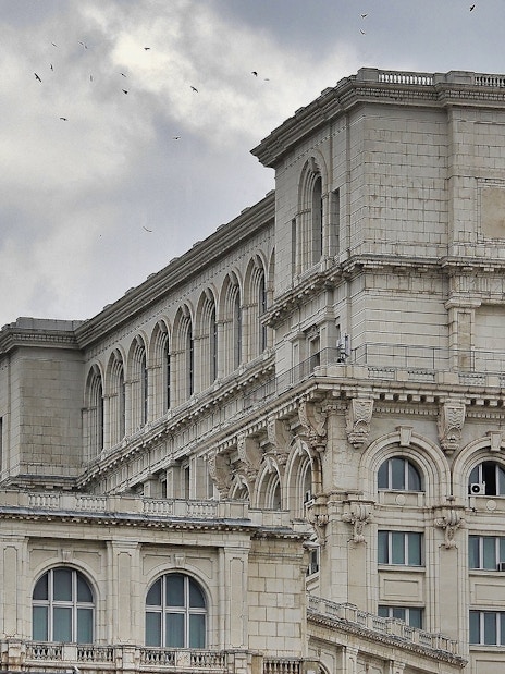 Palace of Parliament facade with arched windows in Bucharest, Romania.