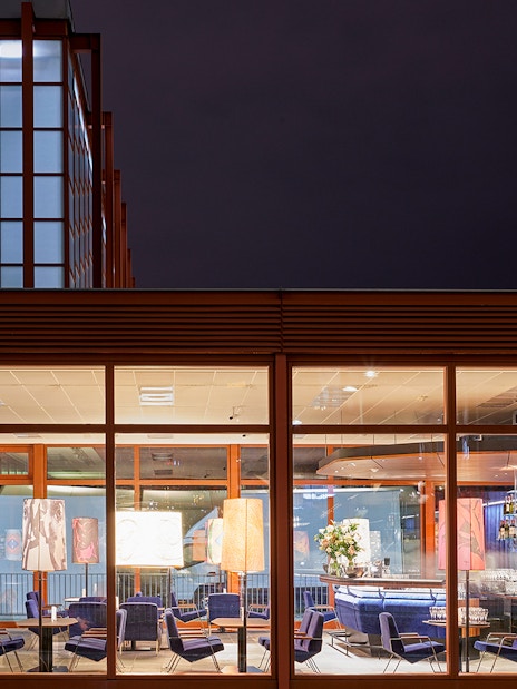 Belvedere Museum of Contemporary Art exterior with illuminated seating area at night.