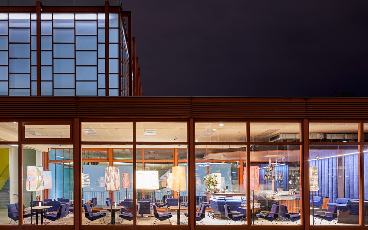 Belvedere Museum of Contemporary Art exterior with illuminated seating area at night.