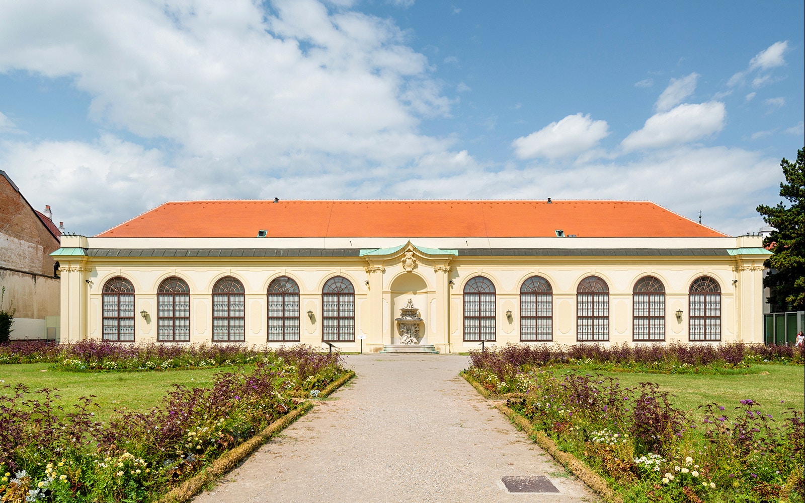Upper Belvedere Palace garden view, Vienna, with historic architecture and vibrant flower beds.