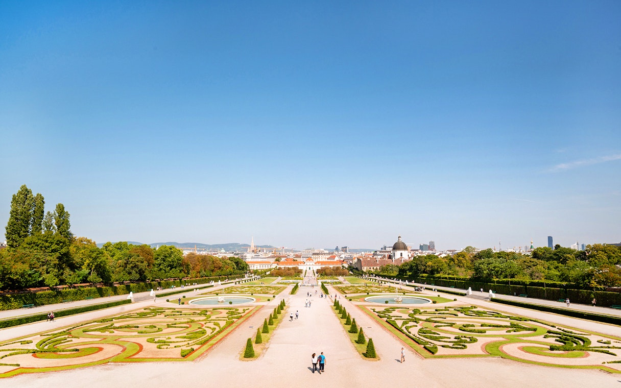 Lower Belvedere Palace gardens in Vienna with city skyline in the background.