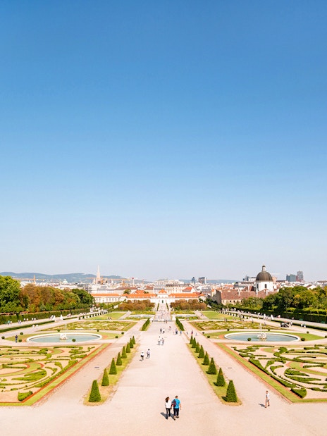Lower Belvedere Palace gardens in Vienna with city skyline in the background.