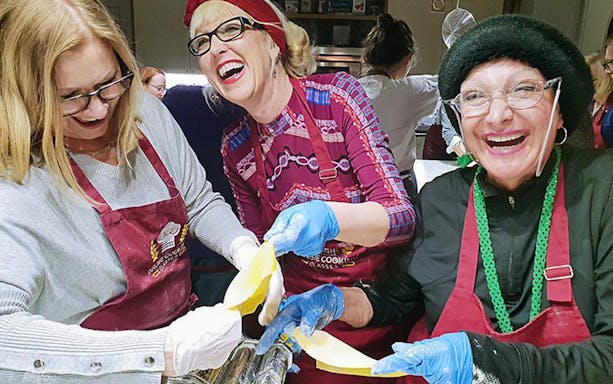 Participants enjoying pasta making in a small group cooking class.