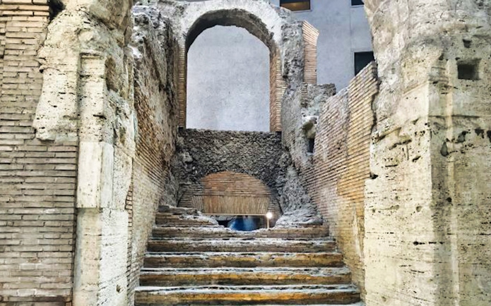 Ancient stone steps and archway in Rome's historic center.