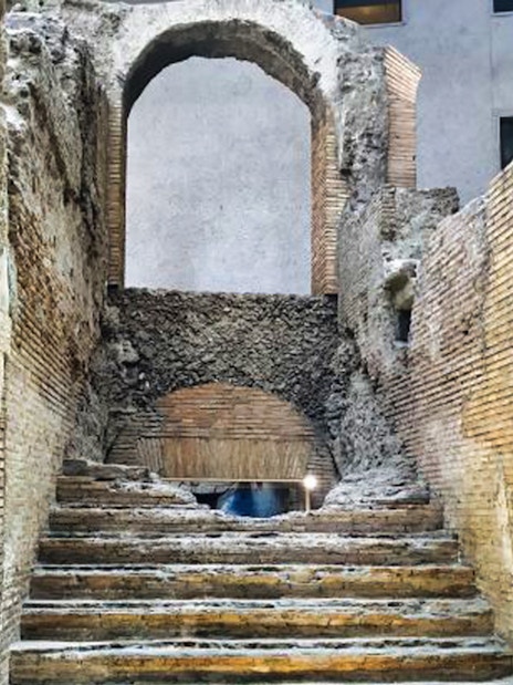Ancient stone steps and archway in Rome's historic center.