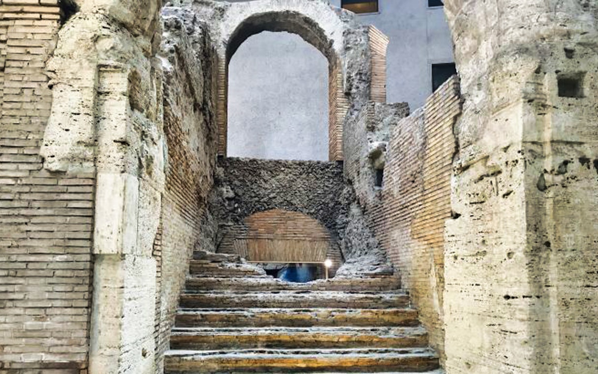 Ancient stone steps and archway in Rome's historic center.