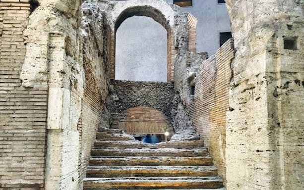 Ancient stone steps and archway in Rome's historic center.
