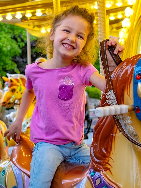 Children enjoying a carousel ride at Energylandia Amusement Park.