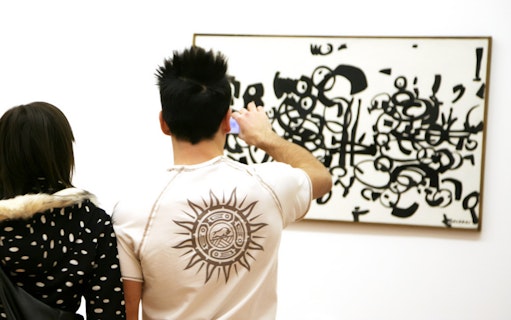 Visitors viewing abstract art at Galleria Civica d'Arte Moderna e Contemporanea.