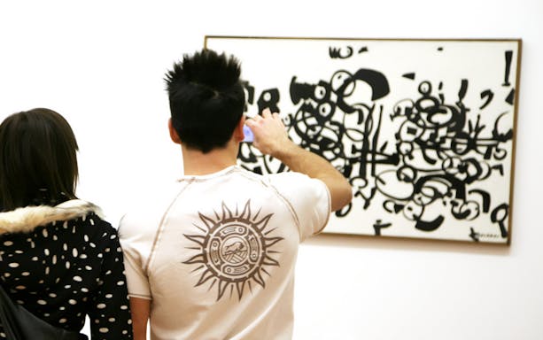 Visitors viewing abstract art at Galleria Civica d'Arte Moderna e Contemporanea.