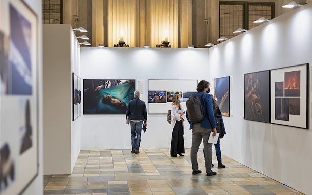 Visitors viewing art exhibits at Palazzo Madama, Turin.