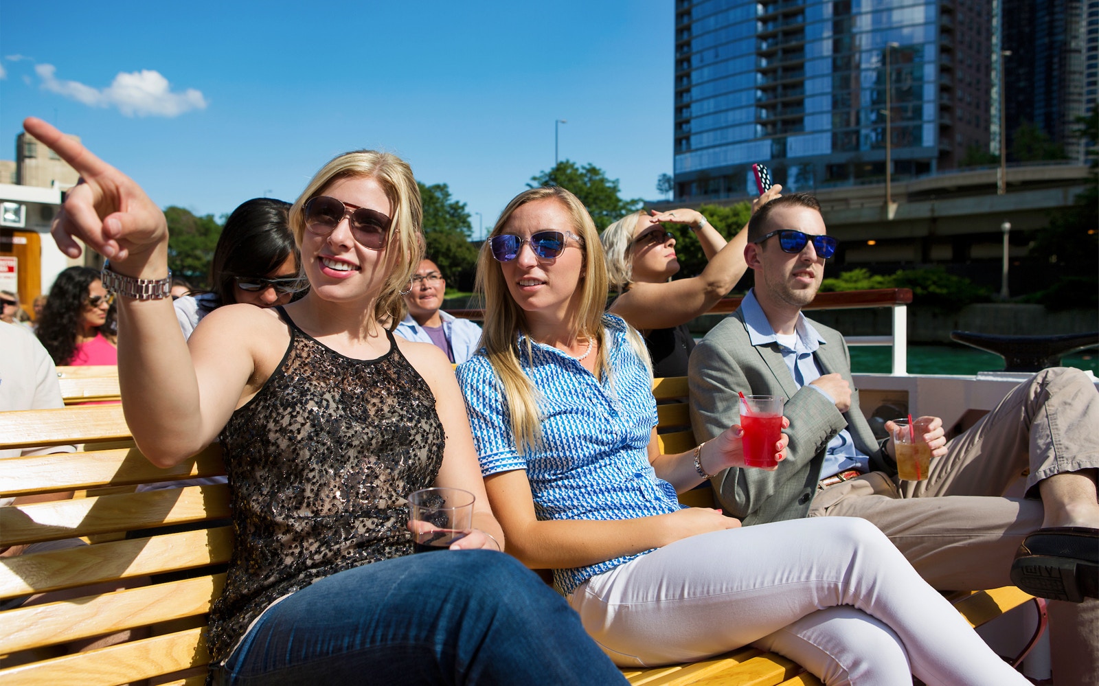 People enjoying a Chicago River architecture cruise near Michigan Avenue.
