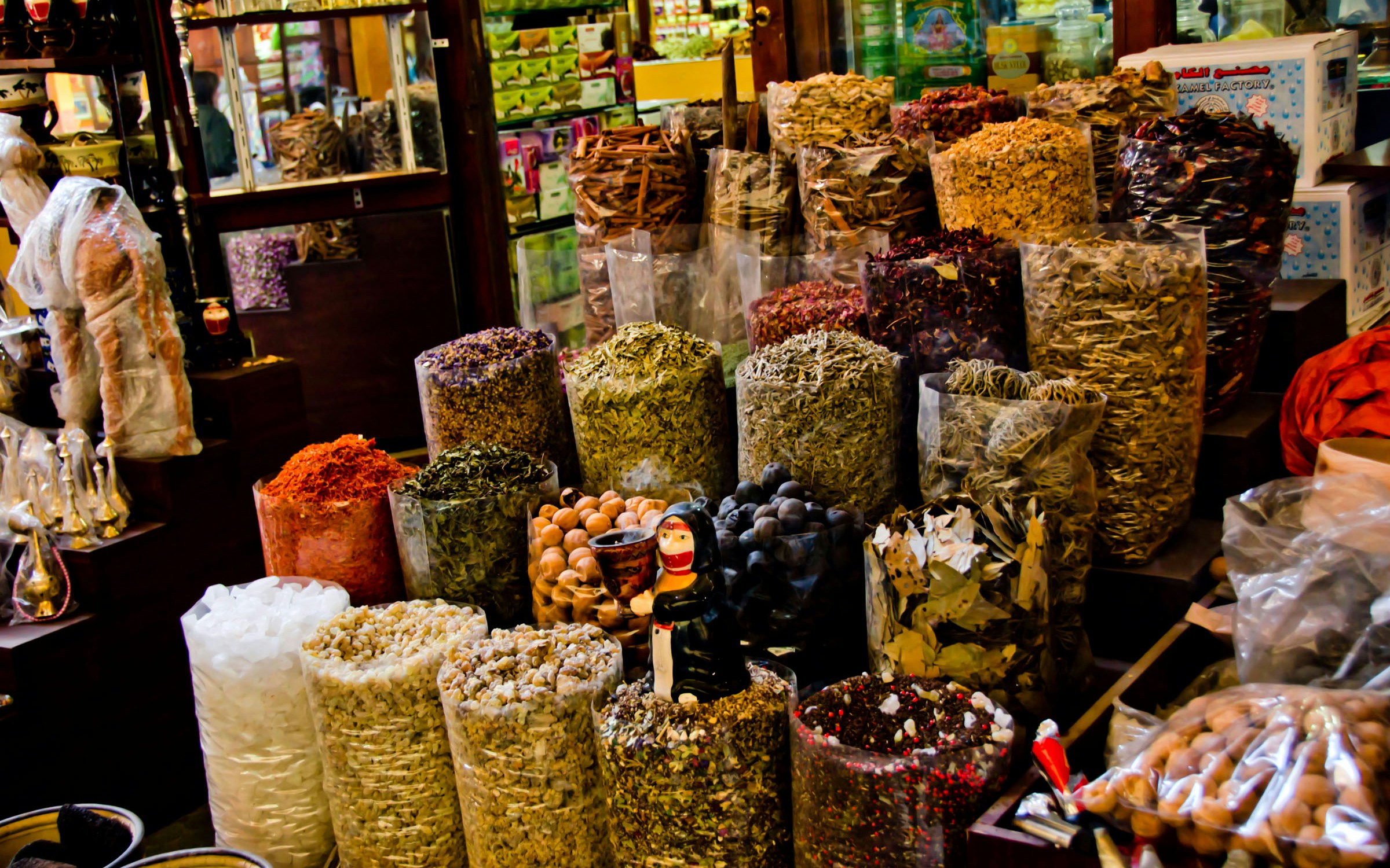 Spices and herbs displayed in bags at a Dubai souk.