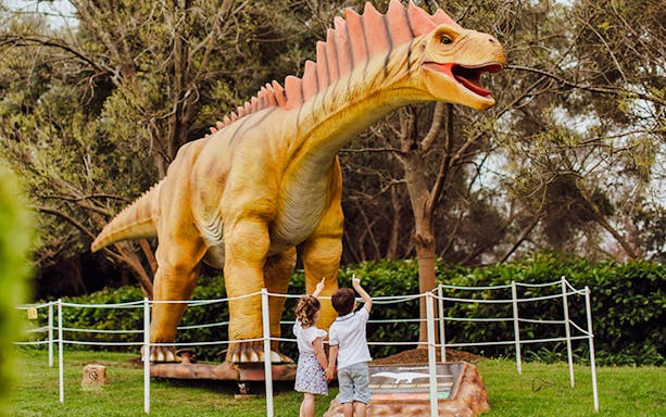 Children pointing at a dinosaur sculpture at Mega Creatures Event, Hunter Valley Gardens.