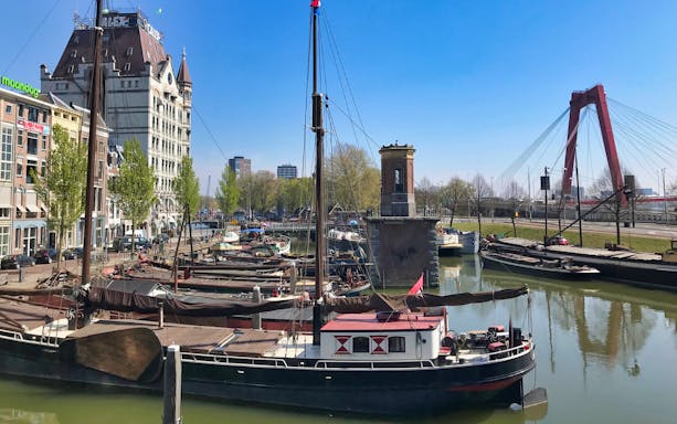 Boats docked near Rotterdam's White House and Willemsbrug on Markthal tour.